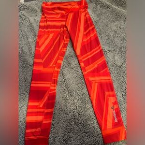 Woman’s size small red and orange Reebok running leggings. Size small.
